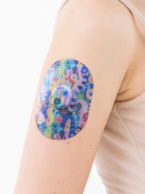 Colorful Dexcom G7 sensor patch with childhood-inspired design on arm.