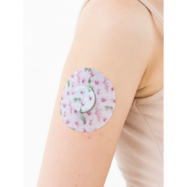 Spring-themed Freestyle Libre 2 patch on arm, secure and stylish adhesive for active lifestyles.