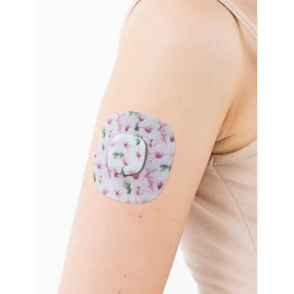 Simplera Sensor Patch on arm with colorful design, providing secure and durable protection for Medtronic Simplera CGM sensor.