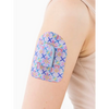 Omnipod Dash patch with spring floral design on person's arm.