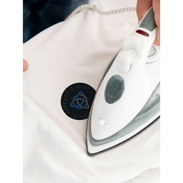 Diabetes awareness iron-on patch being applied to clothing with an iron, featuring a Viking-themed design.