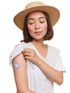 Woman wearing Freestyle Libre 3 sensor patch in spring-inspired design.