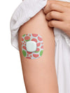 Simplera Sensor Patch with watermelon print on arm, skin-safe adhesive, part of 3-pack design set.