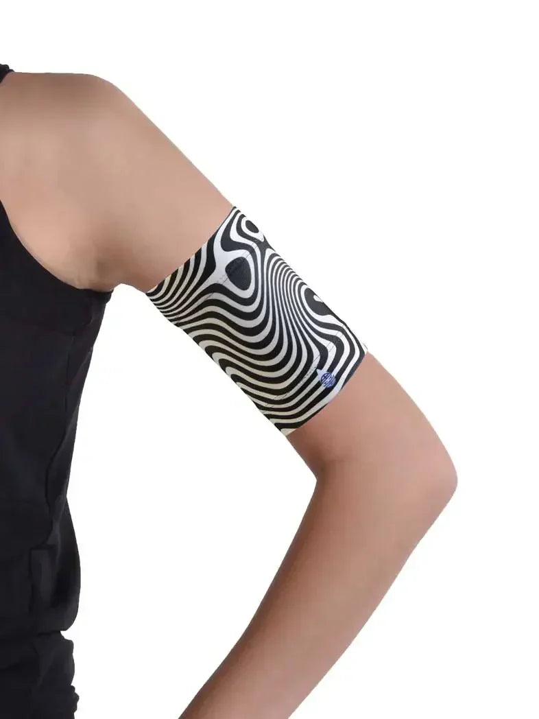 Blood glucose monitor armband with black and white pattern for protecting glucose sensors.