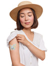 Dexcom G7 butterfly shape patch worn on a woman’s arm, with breathable adhesive fabric for sensor support