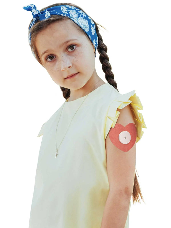 Freestyle Libre 2 heart patch worn by girl child friendly CGM adhesive patch with gentle skin compatibility