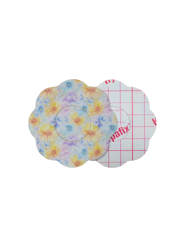 FreeStyle Libre 2 cookie shape patch front and back view, showing printed fabric and adhesive side for sensor support