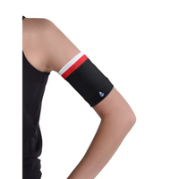 Black glucose monitor and insulin pump armband with red and white stripes worn on upper arm